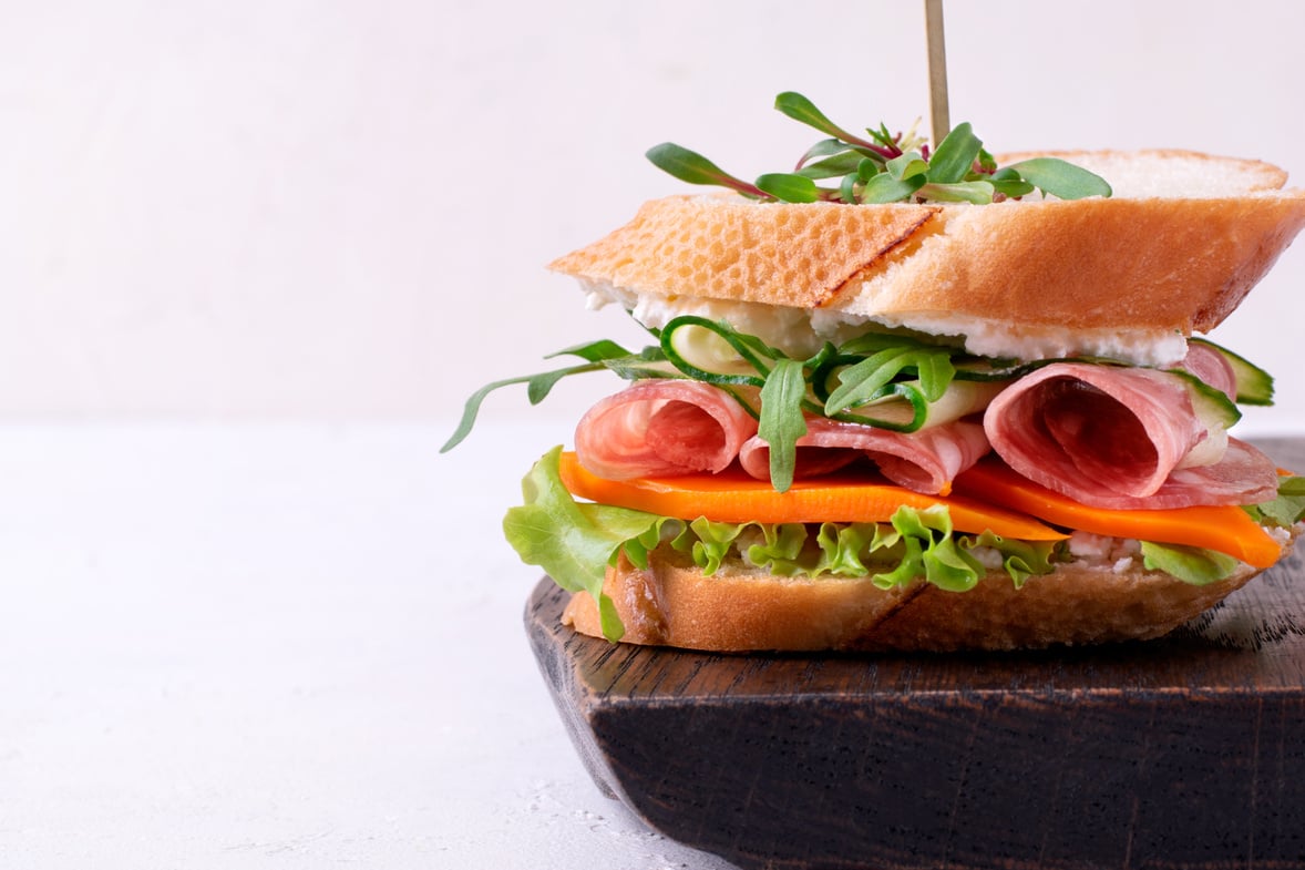 Sandwich with smoked sausage, cheese, vegetables and microgreen